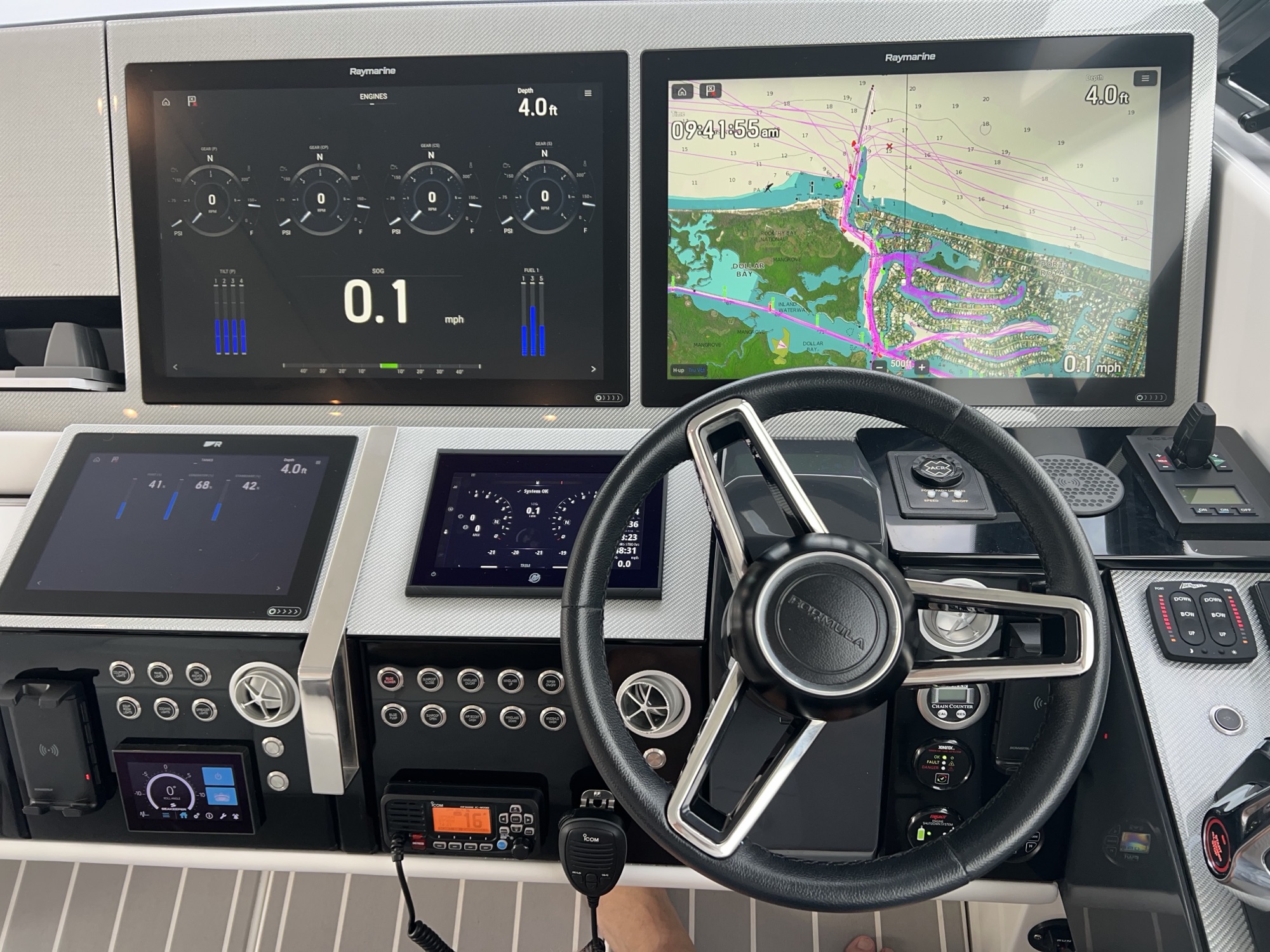 Modern helm with wheel and Raymarine displays